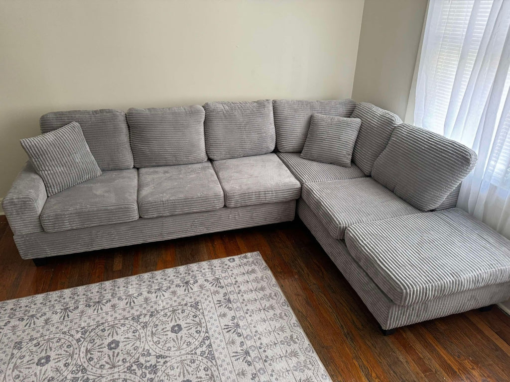 Grey corduroy reversible sectional with drop down cup holders and optional storage ottoman