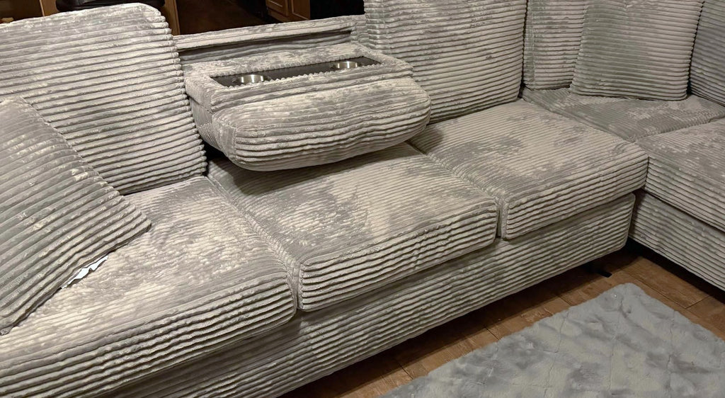 Grey corduroy reversible sectional with drop down cup holders and optional storage ottoman