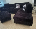 Black corduroy reversible sectional with drop down cup holders and optional storage ottoman
