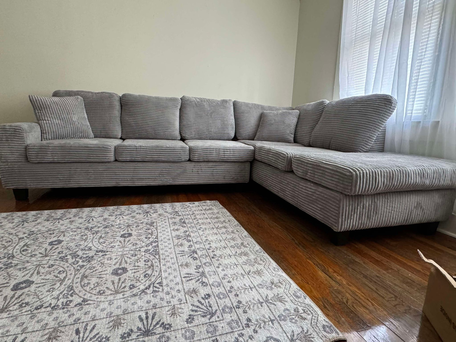 Grey corduroy reversible sectional with drop down cup holders and optional storage ottoman
