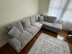 Grey corduroy reversible sectional with drop down cup holders and optional storage ottoman