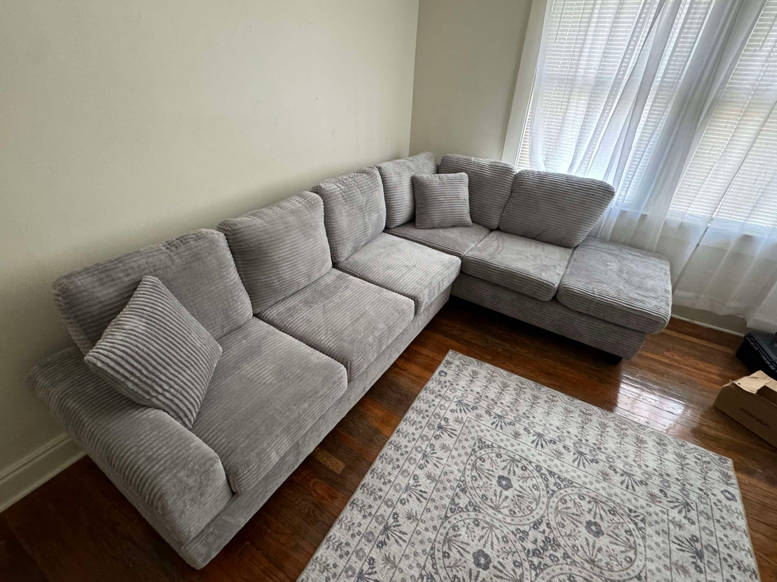 Grey corduroy reversible sectional with drop down cup holders and optional storage ottoman
