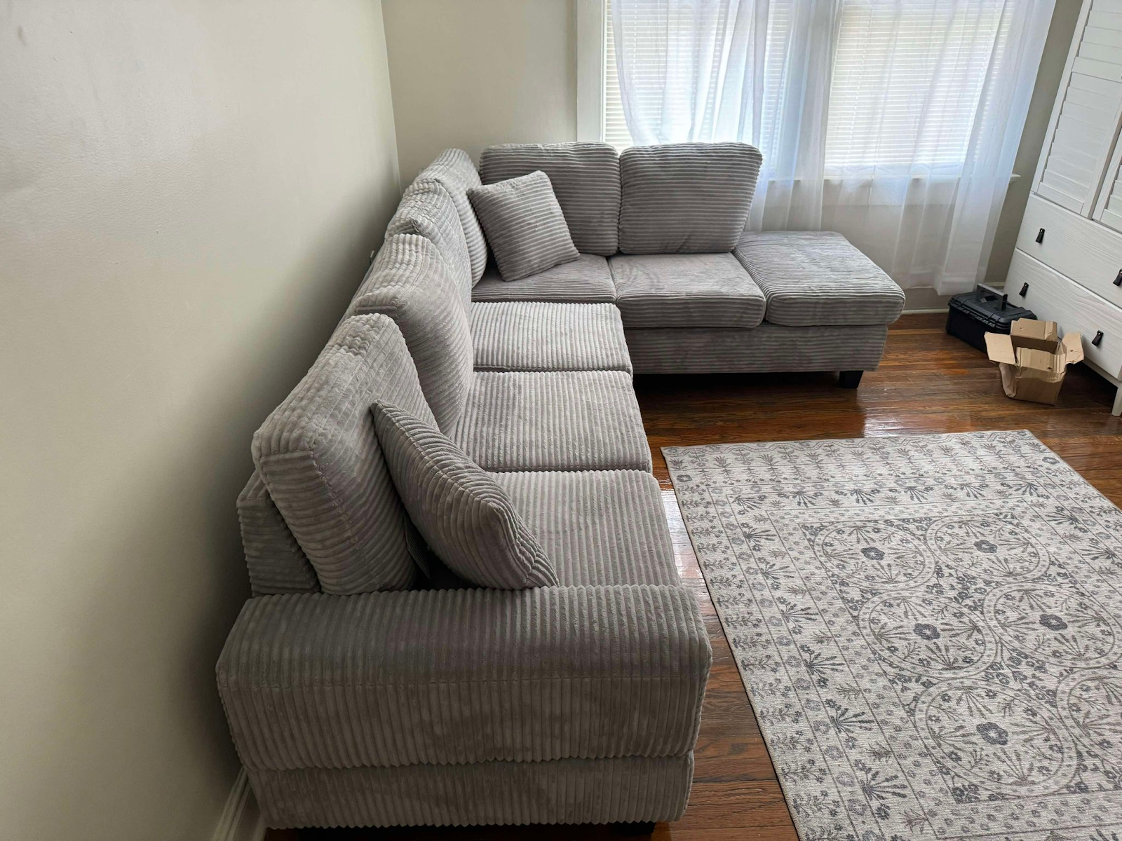 Grey corduroy reversible sectional with drop down cup holders and optional storage ottoman