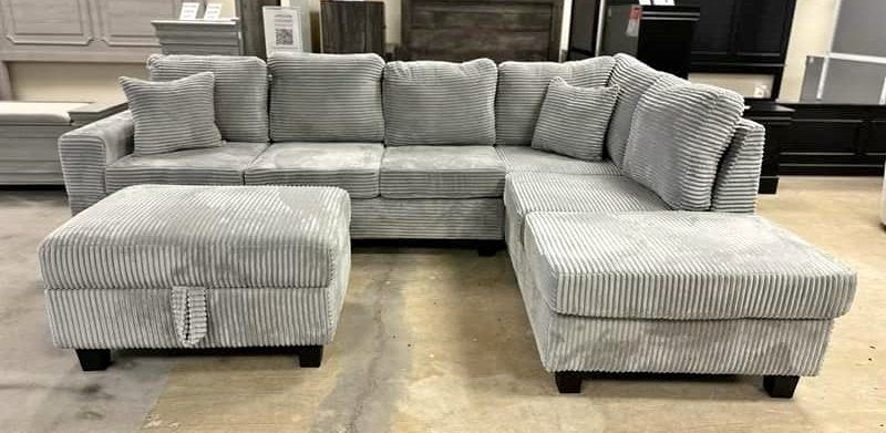 Grey corduroy reversible sectional with drop down cup holders and optional storage ottoman