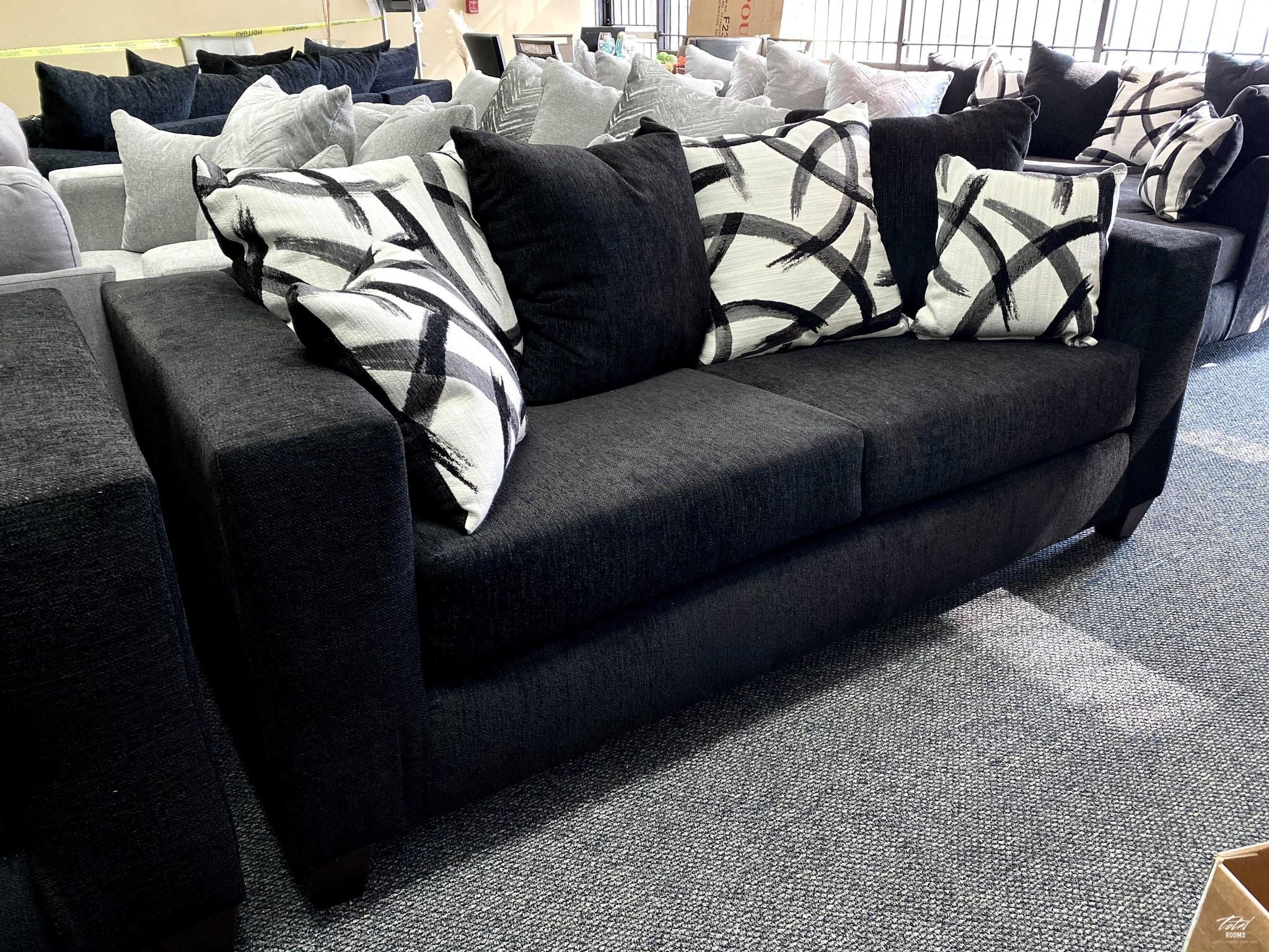 Black sofa and love seat with decorative pillows- new