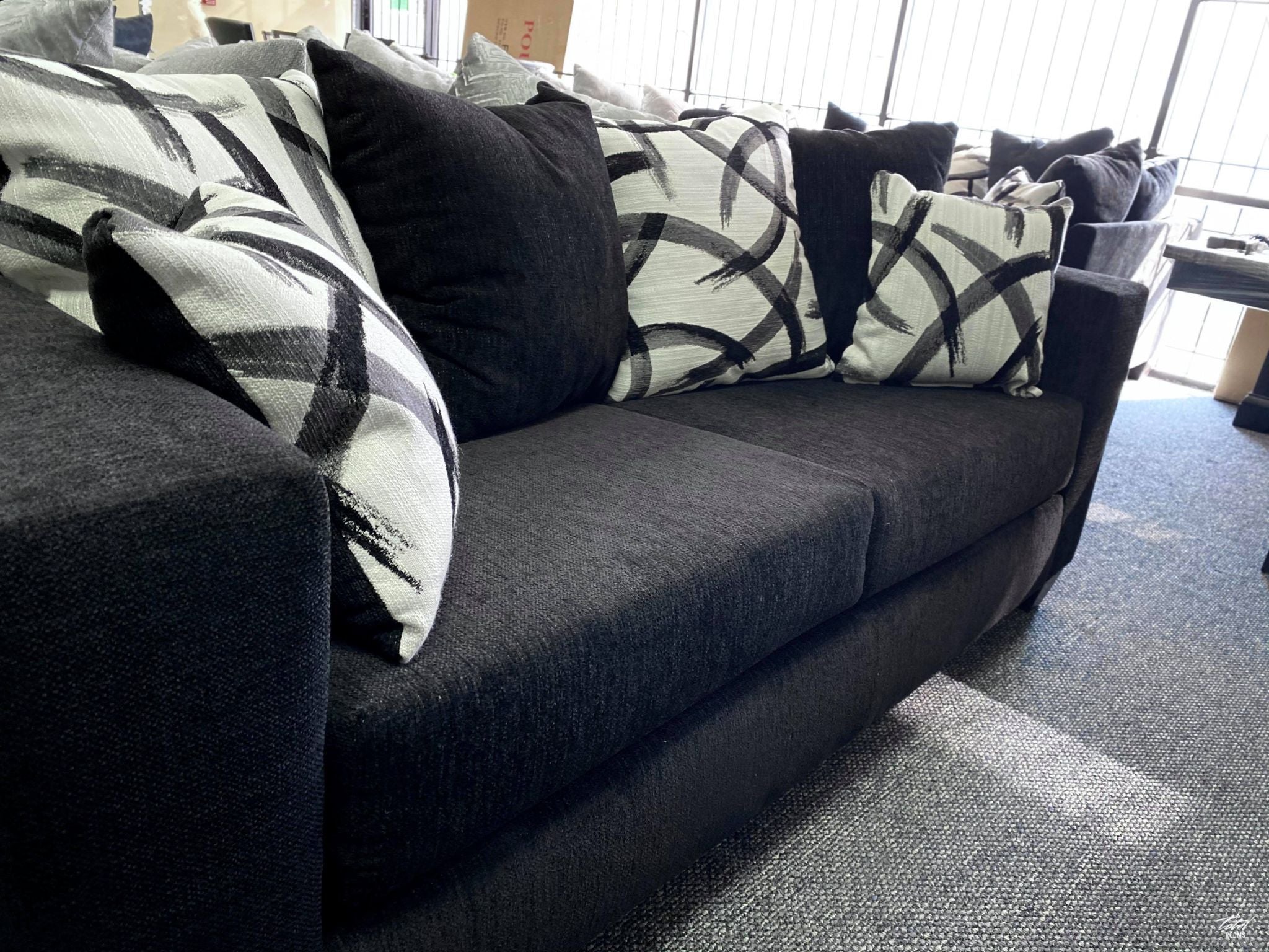 Black sofa and love seat with decorative pillows- new